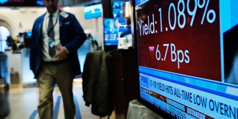 trader in front of bond yield sign