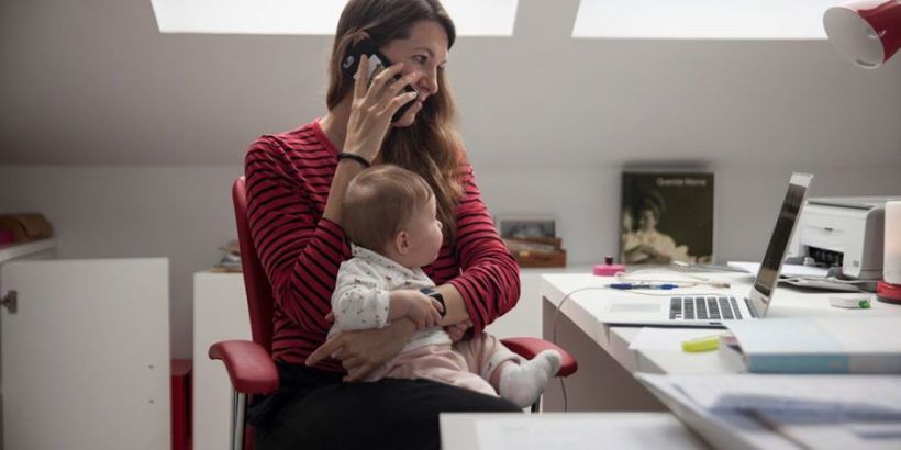 Woman-at-home-at-computer-with-baby-on-her-lap